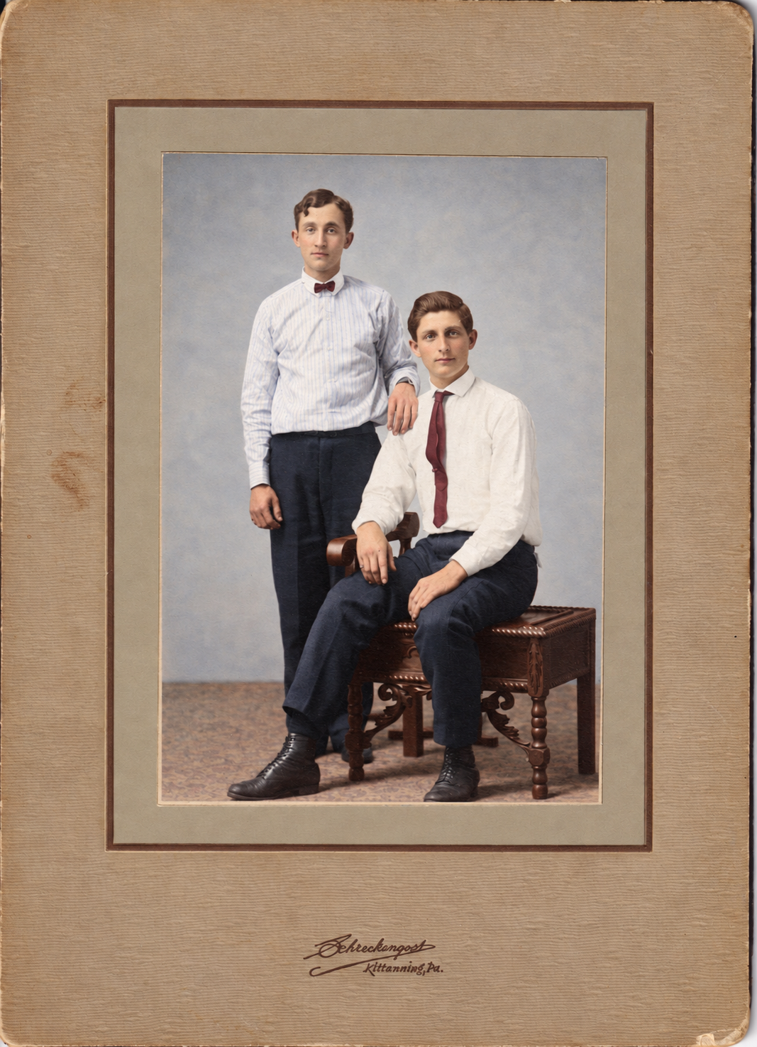 Restored and colorized: John Louis “Happy” Heckman standing, circa 1905, with an unidentified seated companion. Identification and approximate date are family-supplied.