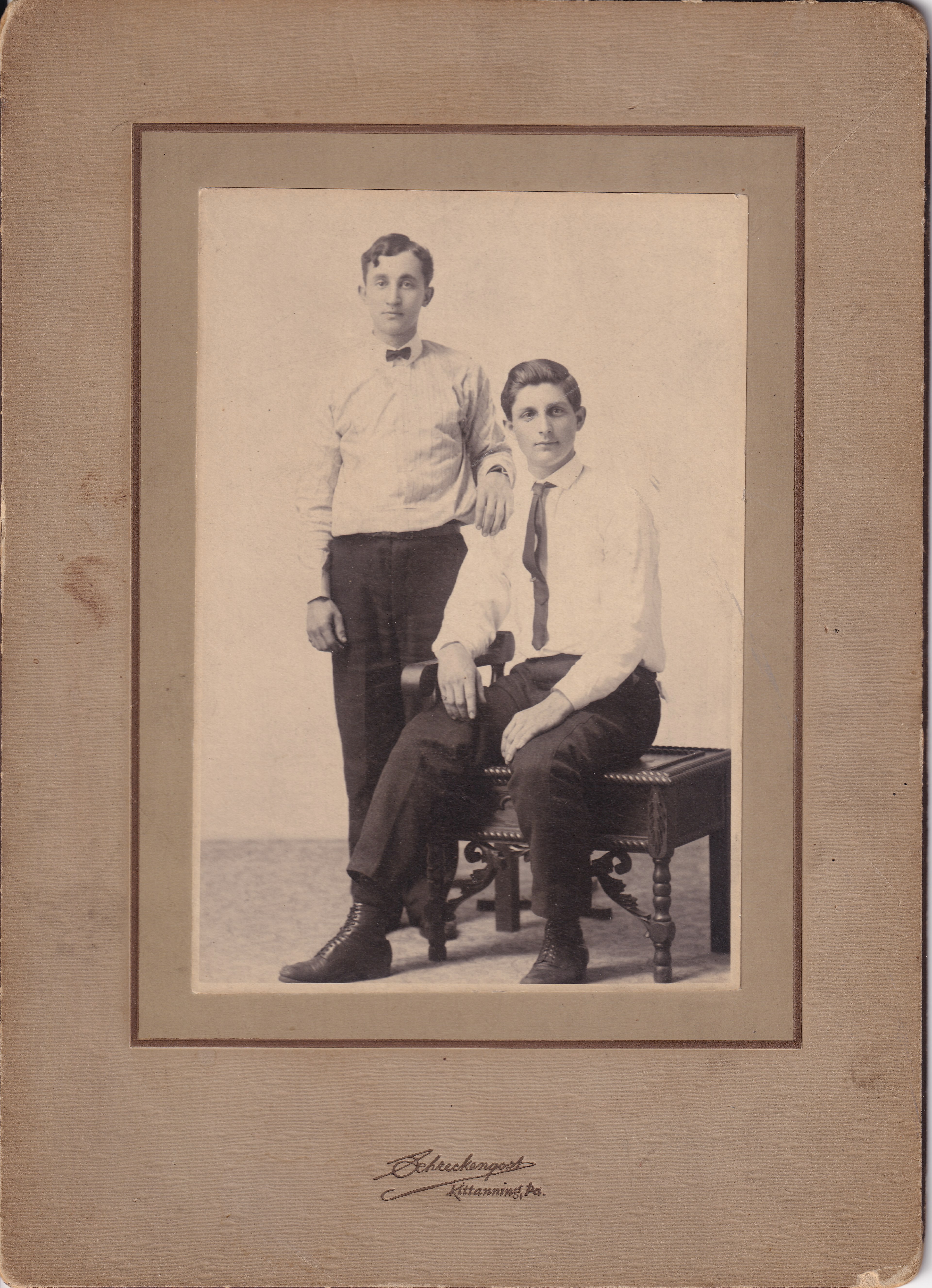 John Louis “Happy” Heckman standing, circa 1905, with an unidentified seated companion. Identification and approximate date are family-supplied.