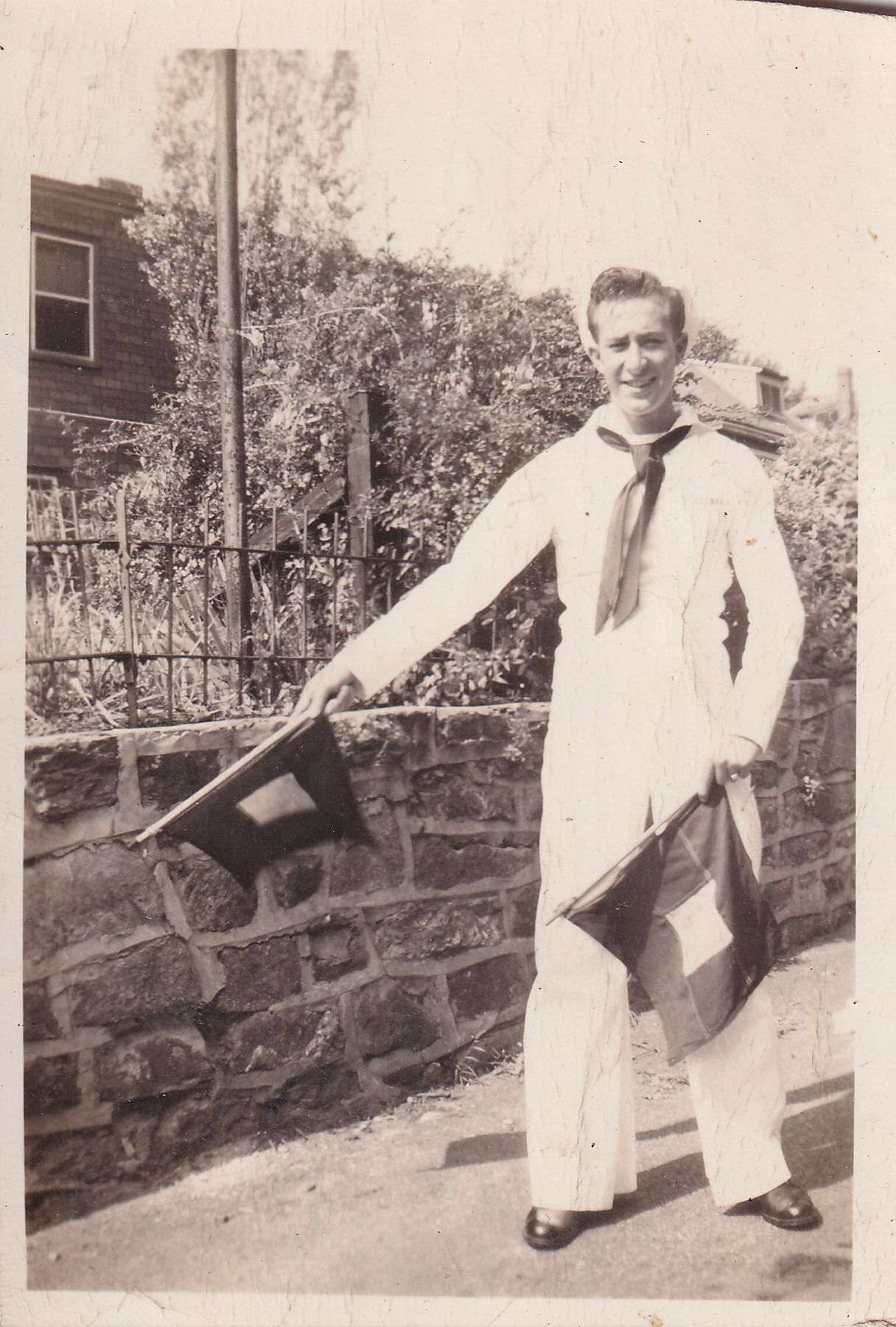 Renay Heckman in Navy uniform holding signal flags